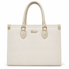 A cream-colored Christian Dior Saffiano leather handbag with gold-tone hardware and a central Dior logo, shown against a plain white background.